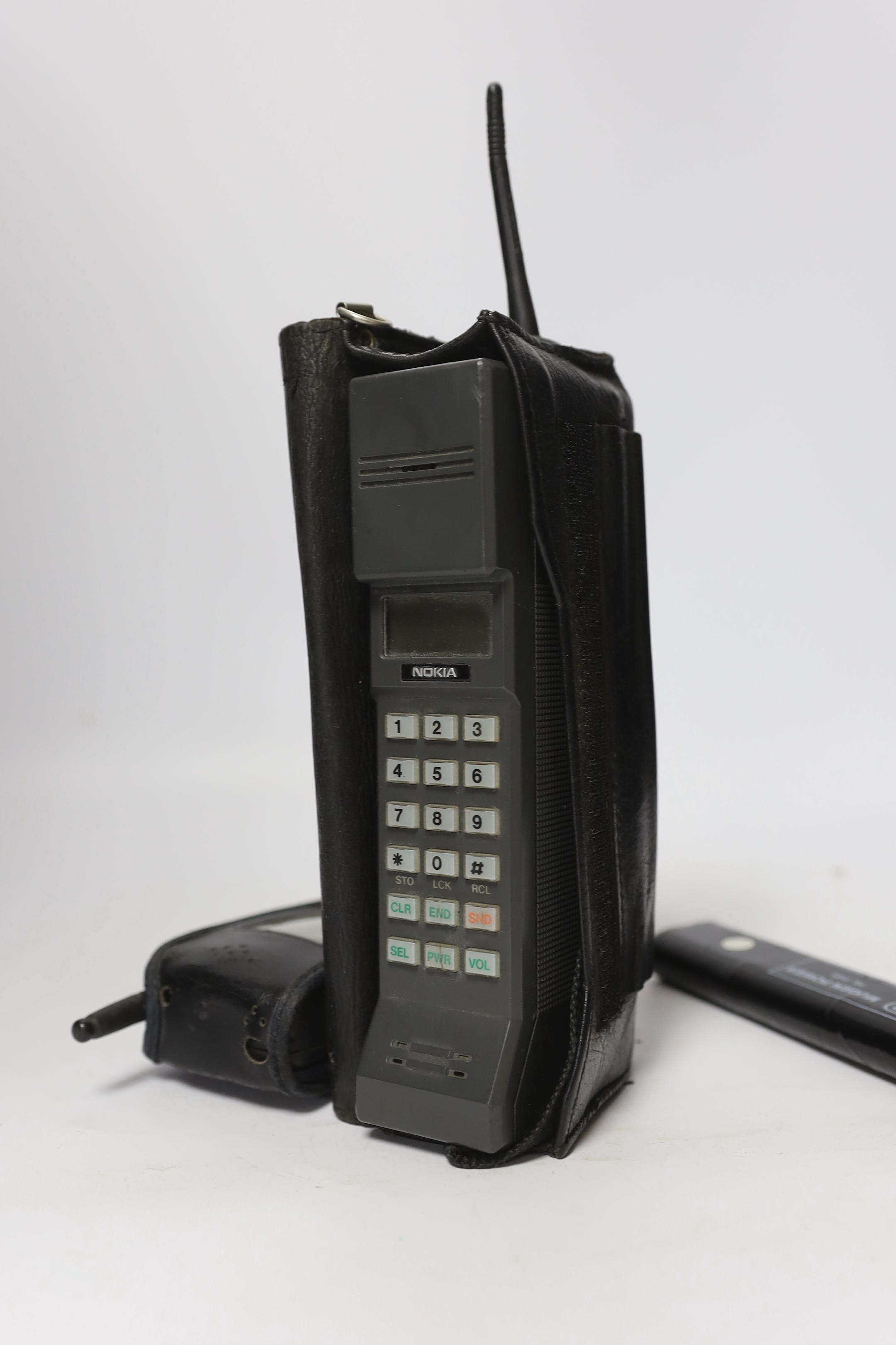 Two early Nokia mobile phones; a late 1980s Cityman 1320 ‘brick’ style analogue phone and a mid-1990s 2110 style GSM phone produced for Orange